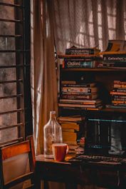 A cozy study nook with a laptop, books, and a steaming cup of coffee by the window.