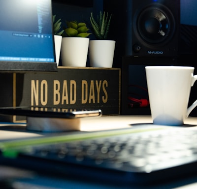 white ceramic mug beside black computer keyboard