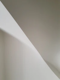 Monochrome abstract shapes overlapping with soft shadows and generous whitespace.