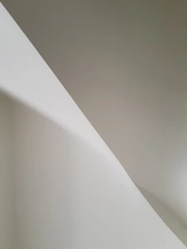 Monochrome abstract shapes overlapping with soft shadows and generous whitespace.