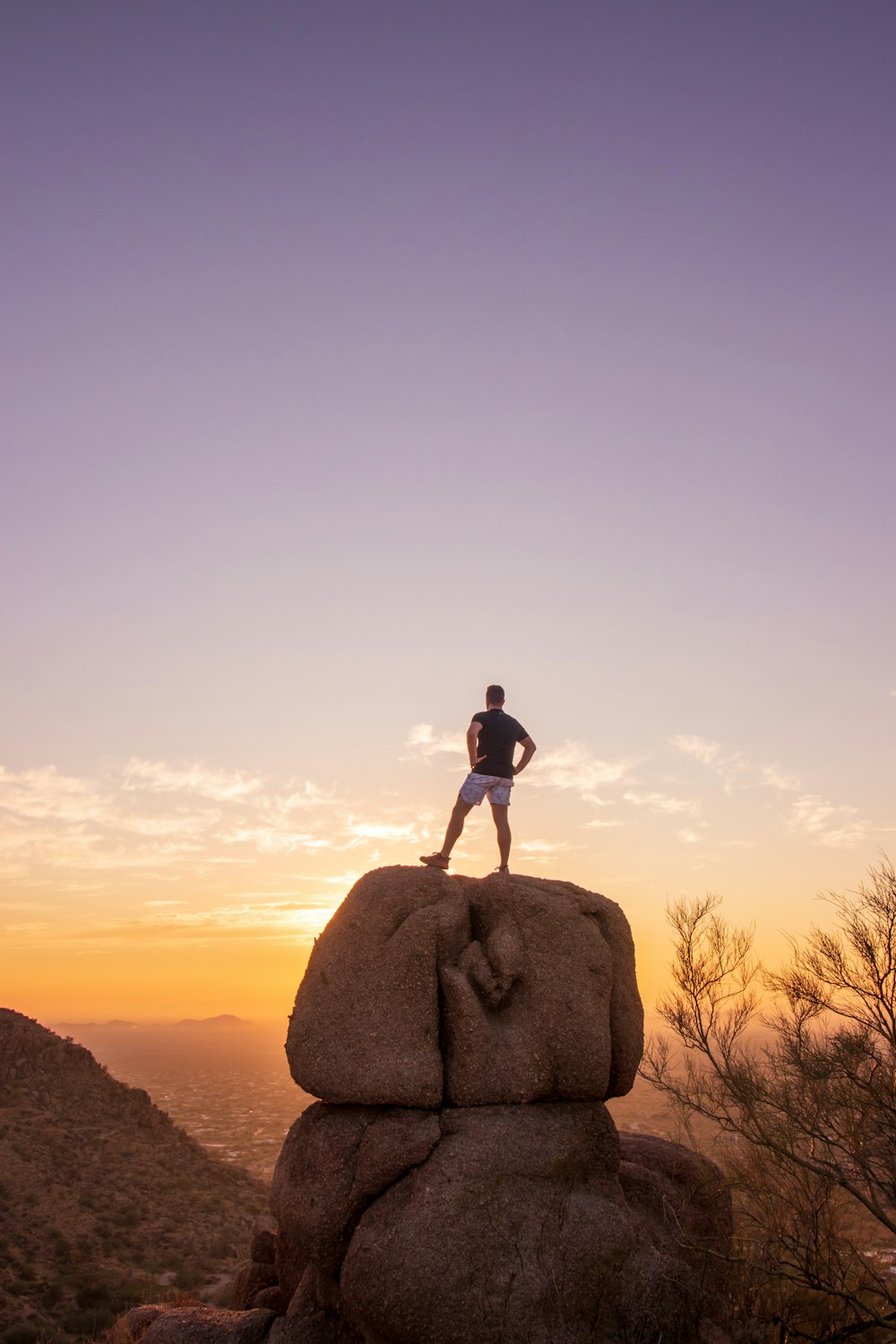 man standing on brown rock during daytime
