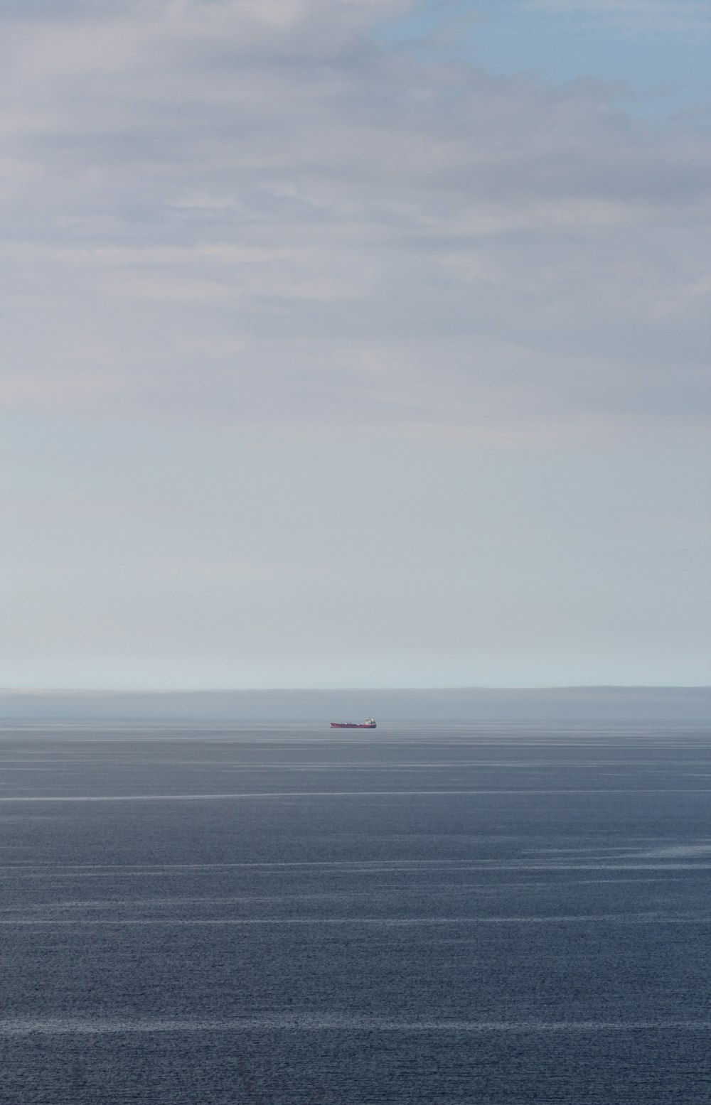 white ship on sea under white sky during daytime