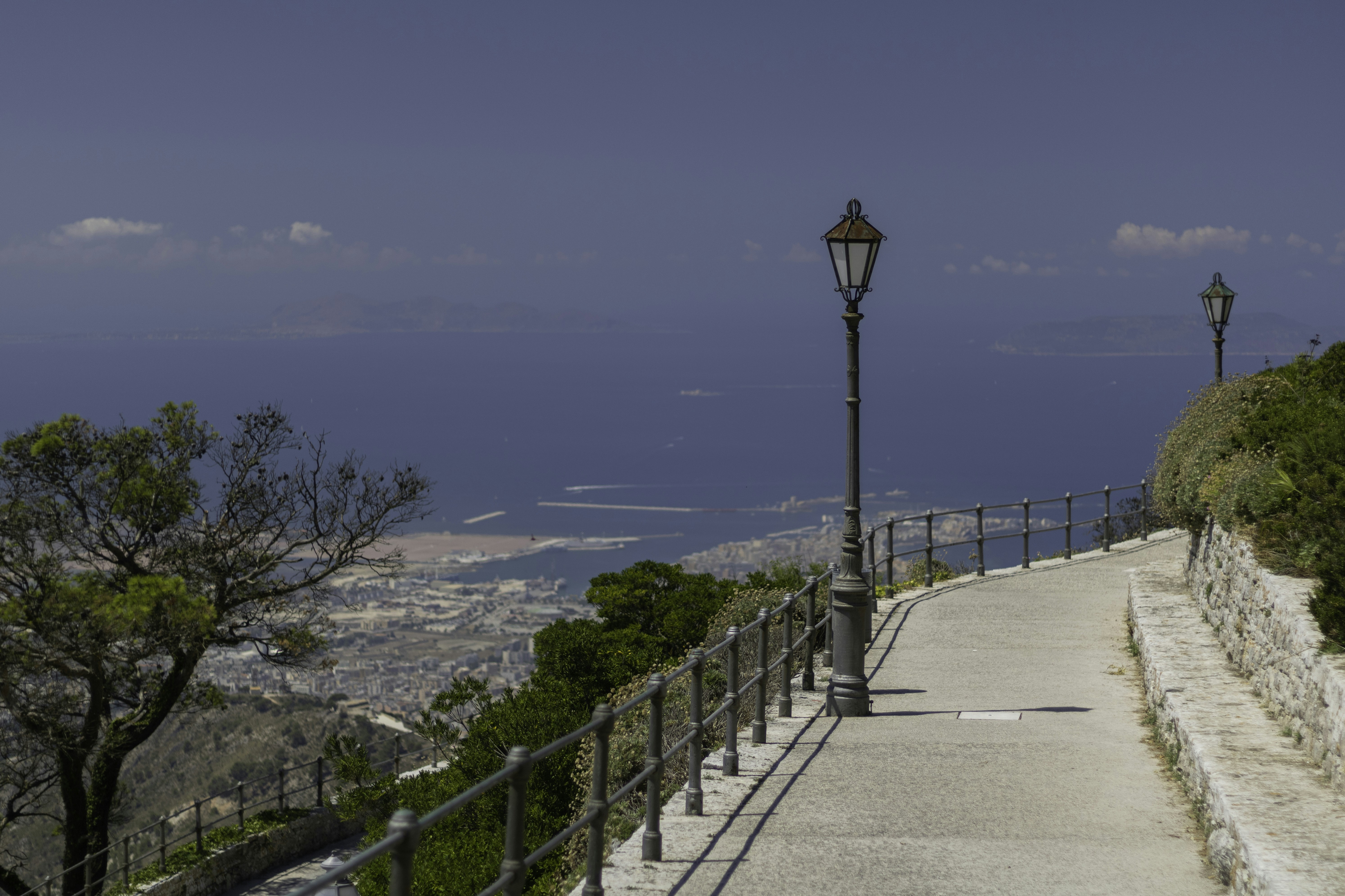 black metal fence near body of water during daytime, 