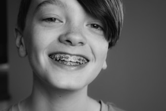 grayscale photo of smiling girl