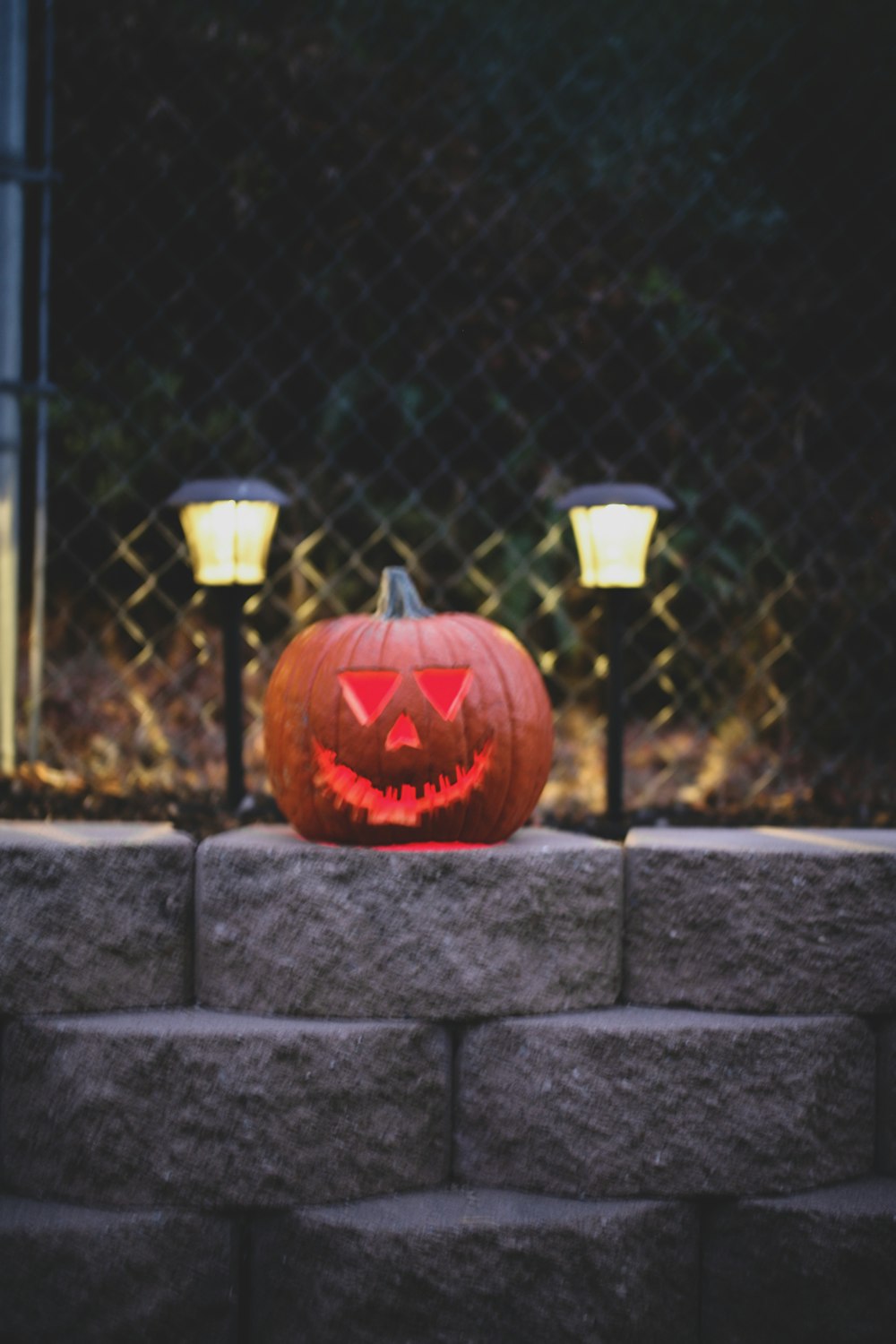 jack o lantern on gray metal fence