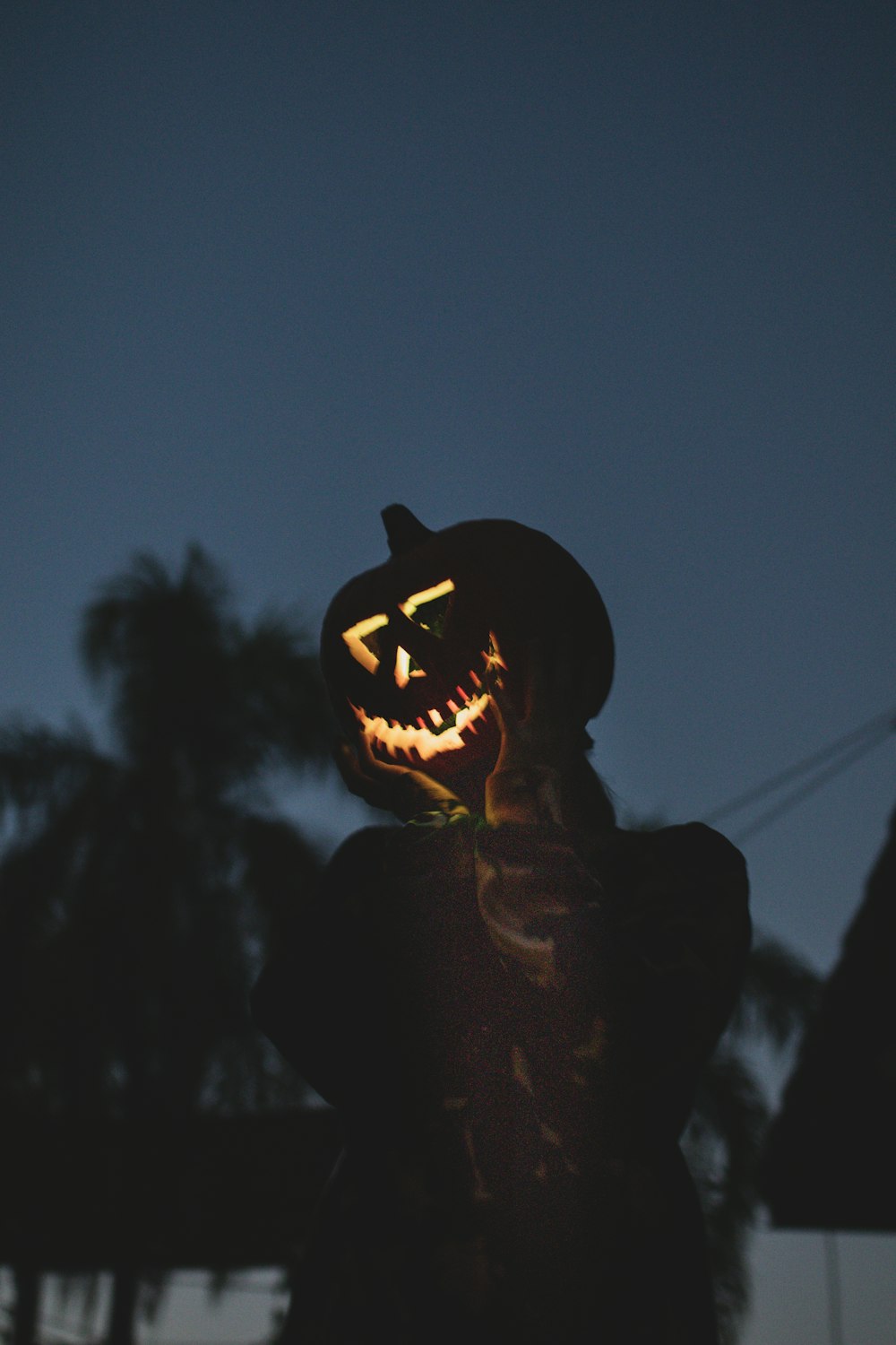 silhouette of person wearing jack o lantern
