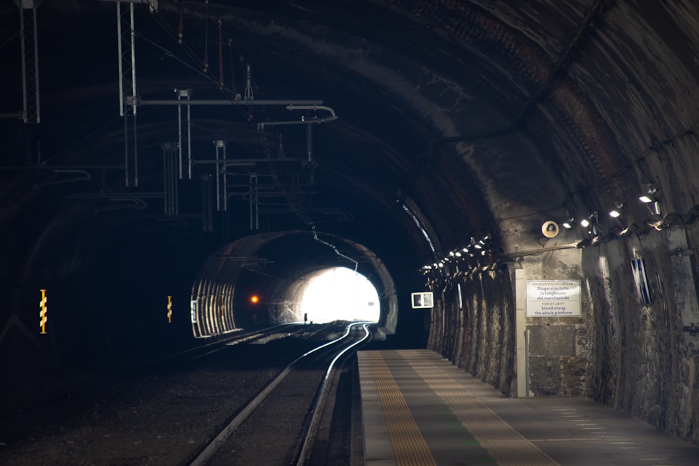 train in tunnel with lights turned on during night time