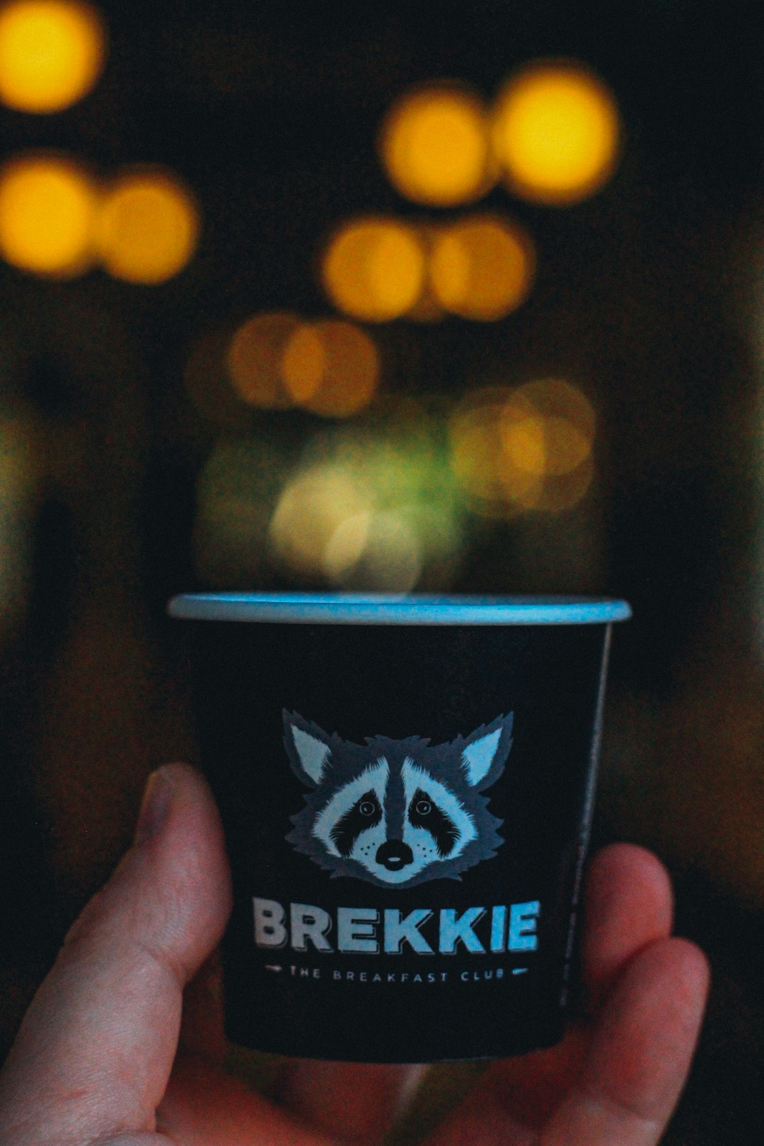 person holding black and white disposable cup