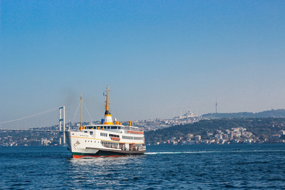 white and orange ship on sea during daytime