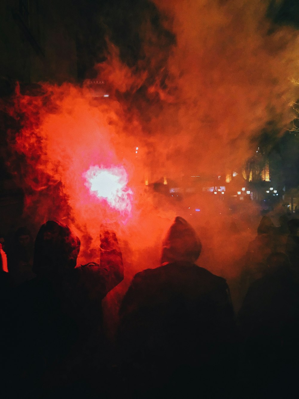 people watching fireworks display during night time