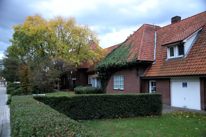 brown and white house near green grass field