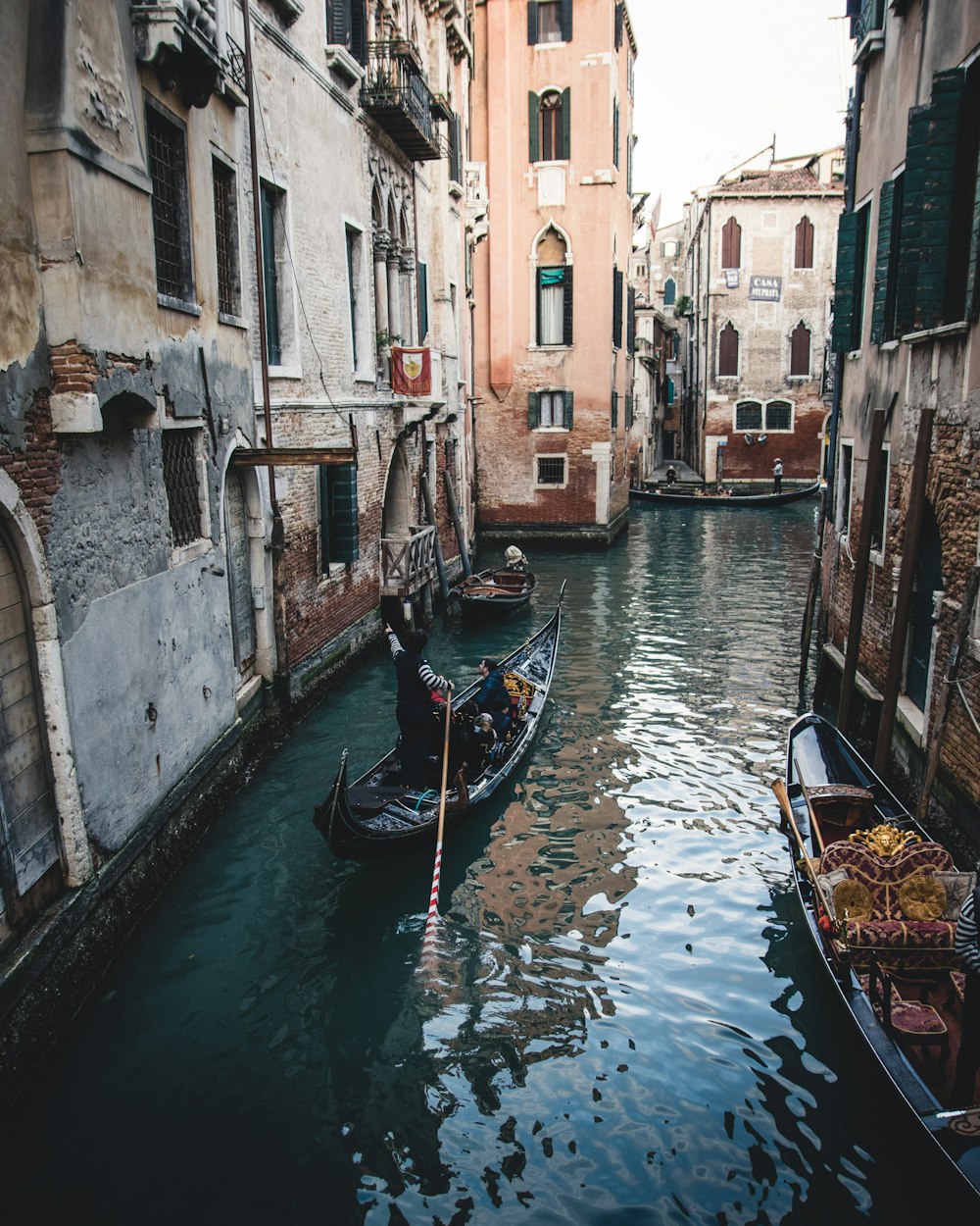 boat on river between buildings during daytime