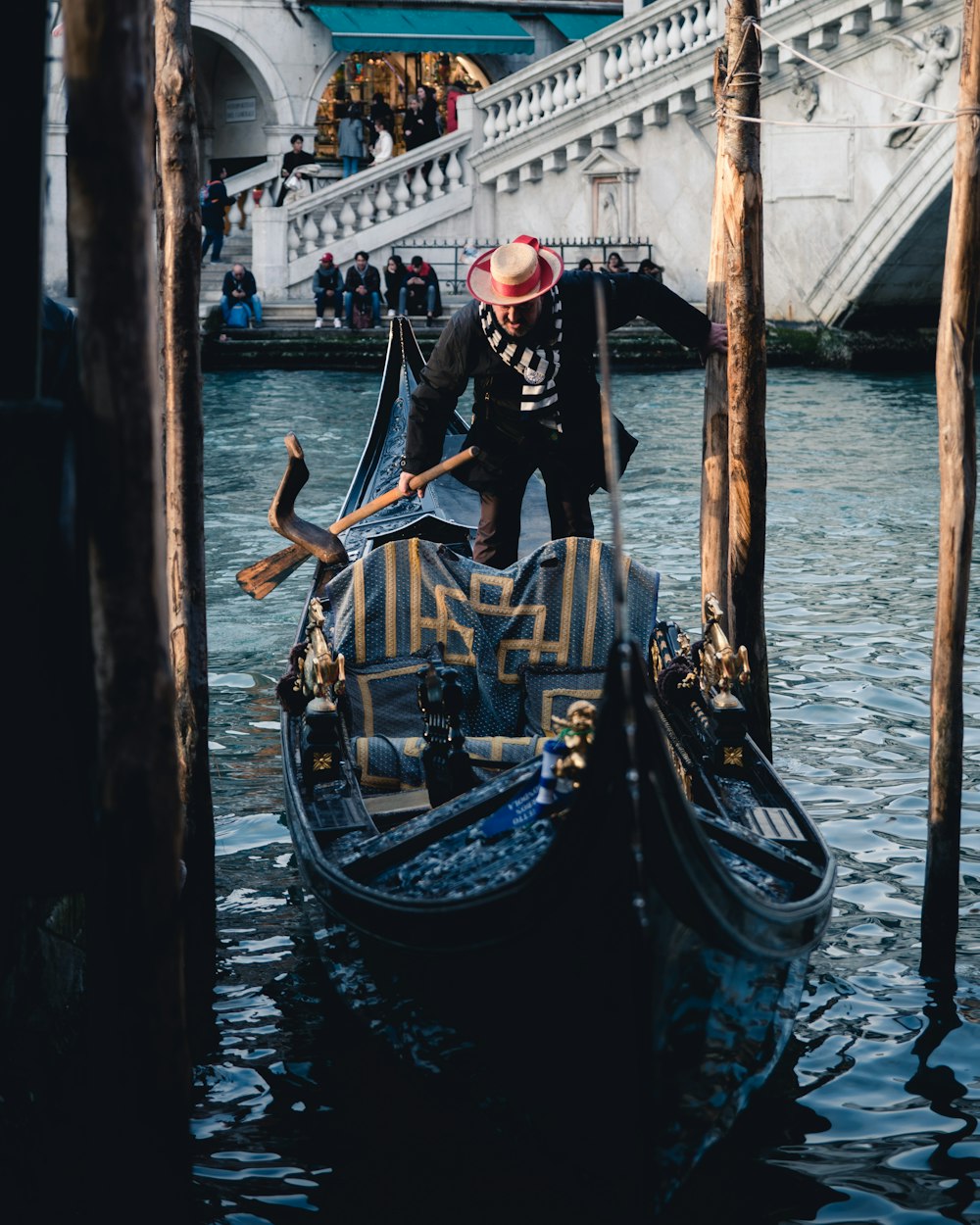 man in black jacket and pants riding on boat during daytime