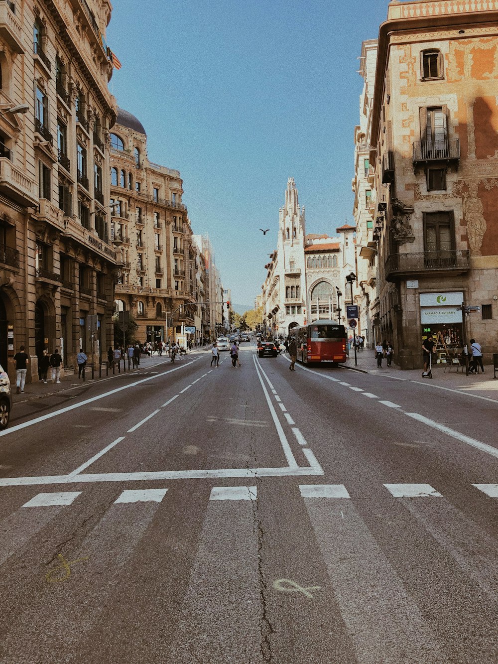 cars on road between buildings during daytime