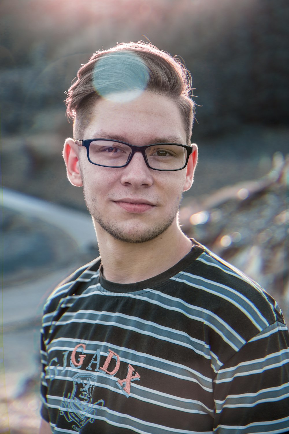 man in black and white striped crew neck shirt wearing black framed eyeglasses