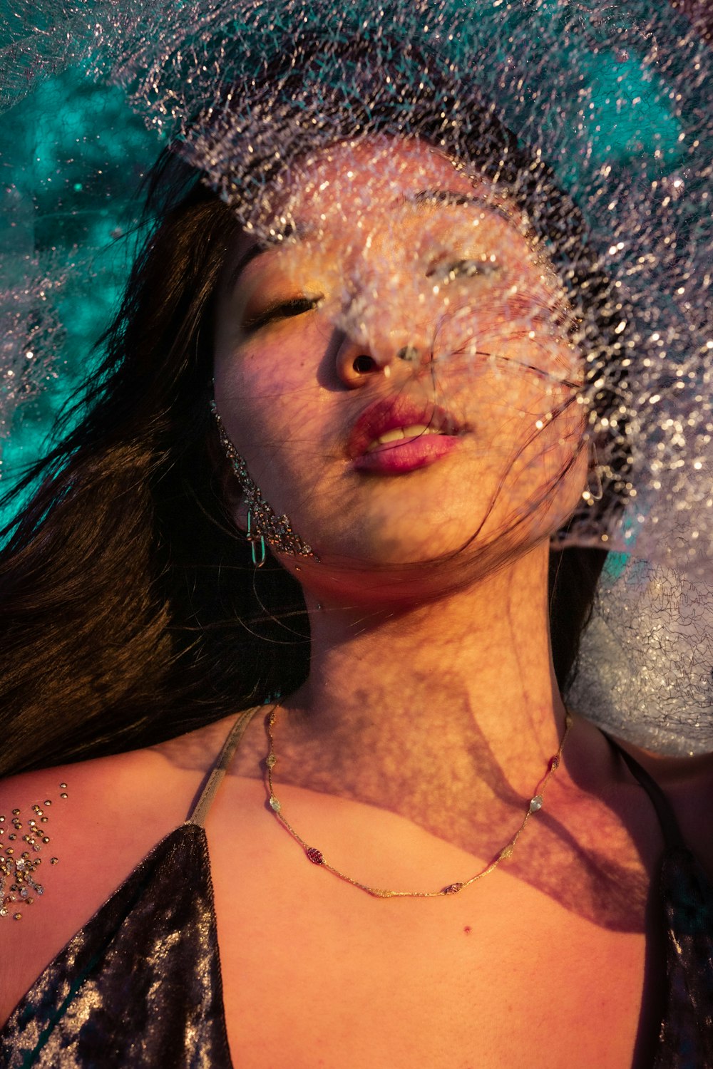 woman in black brassiere with water splash on her face