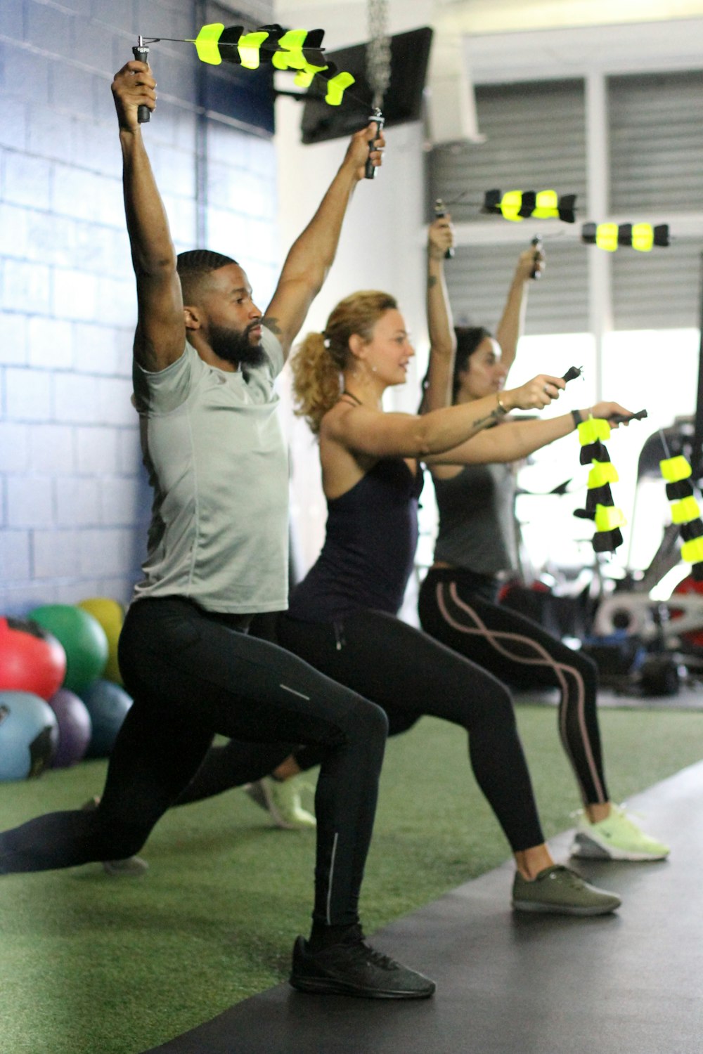 2 women in black tank top and leggings doing yoga