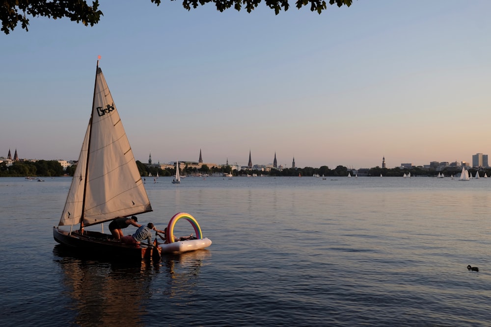 white sail boat on sea during daytime