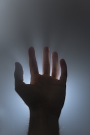 Glitch effect transforming the neon sun into a hand with glowing fingers against a dark, glitchy background.