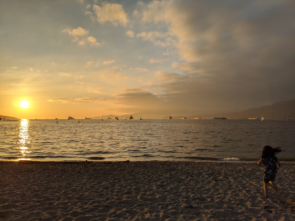 people on beach during sunset