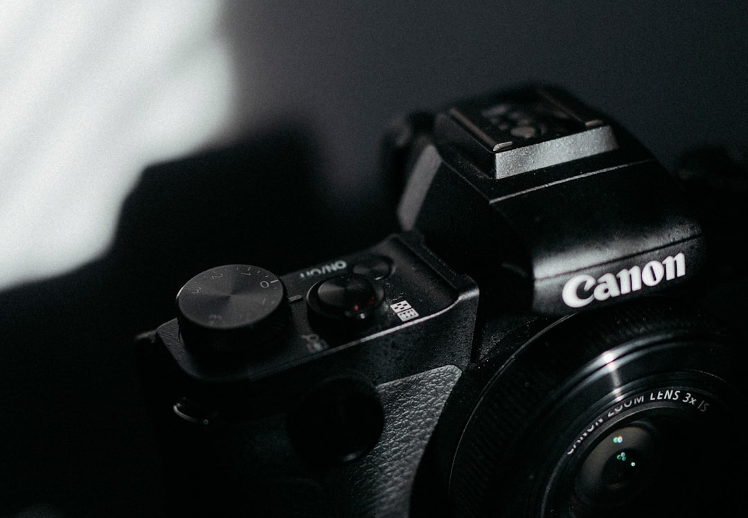 black nikon dslr camera on black table