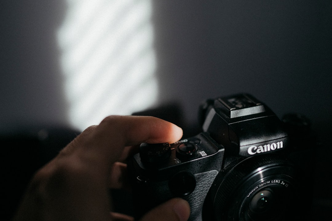 black nikon dslr camera on persons hand