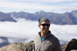 Close-up of a participant’s joyful face, framed by a colorful scarf and mountain backdrop.