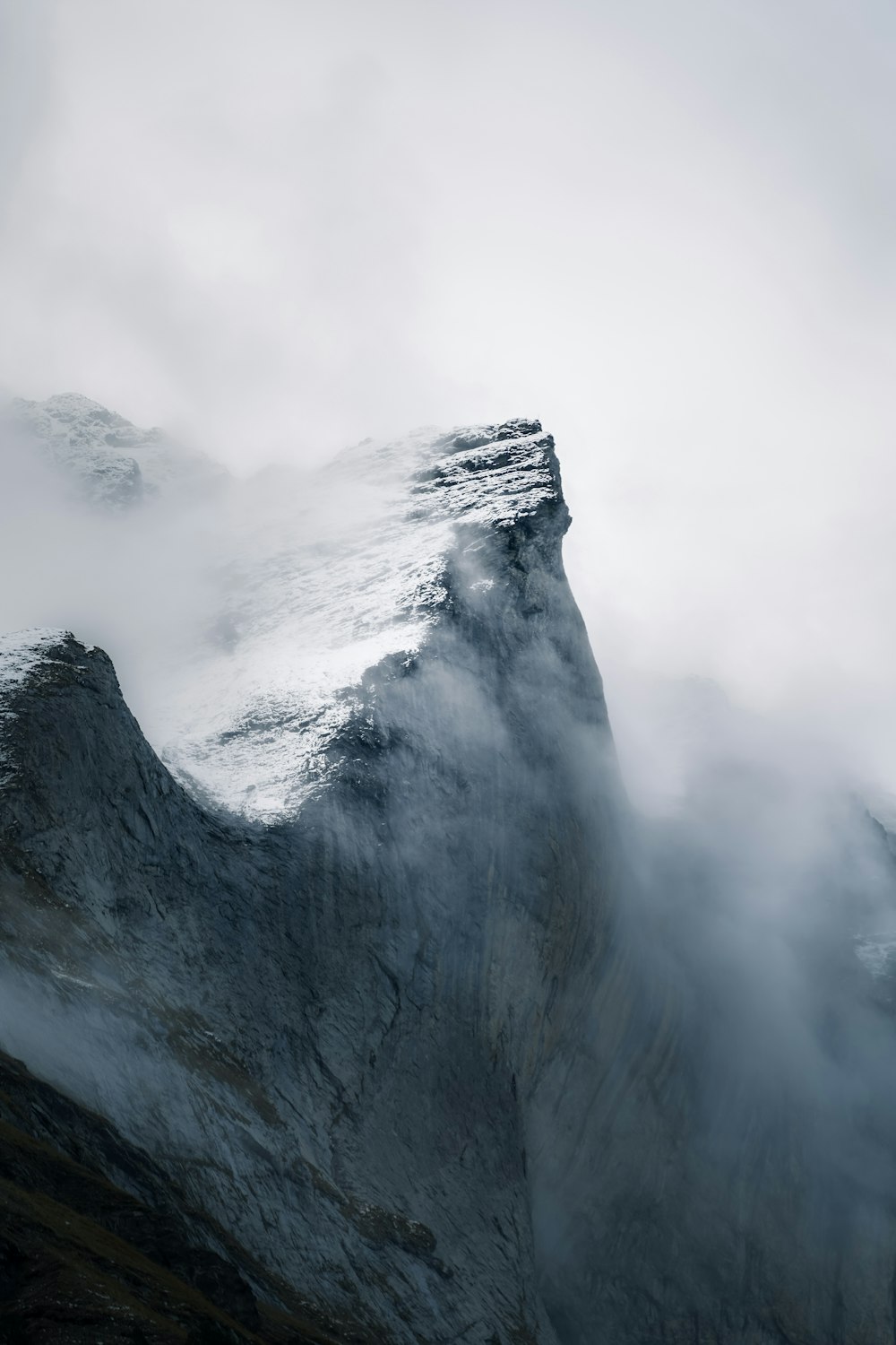 white mountain under white clouds