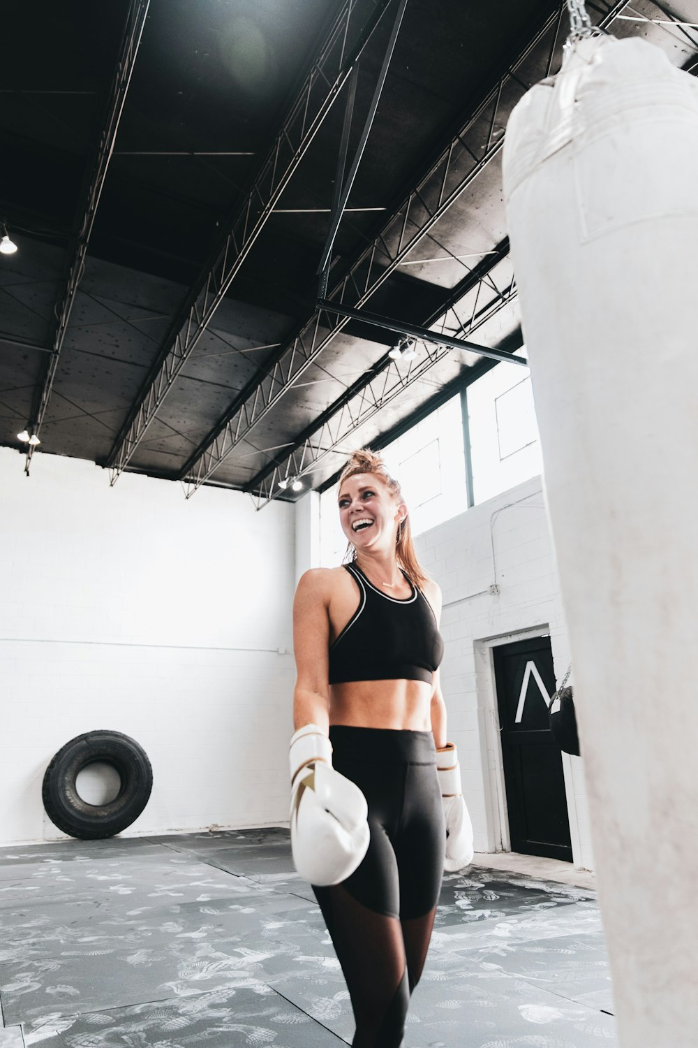 woman in black sports bra and white pants