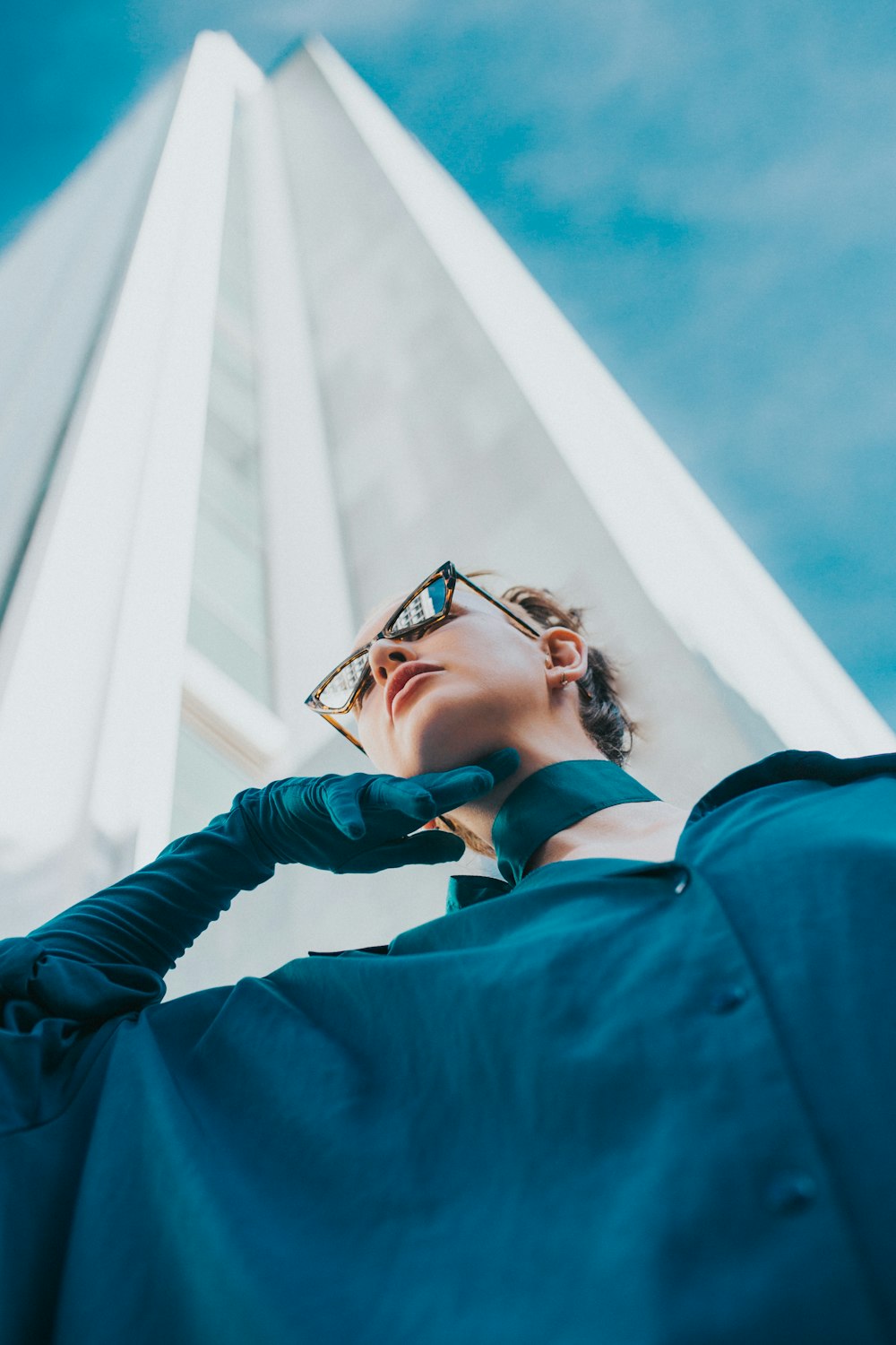 woman in blue jacket wearing black framed eyeglasses