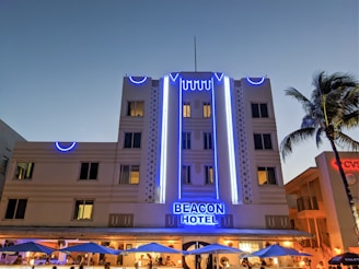Elegant entrance of The Beacon Club with the golden beacon logo glowing softly at dusk.