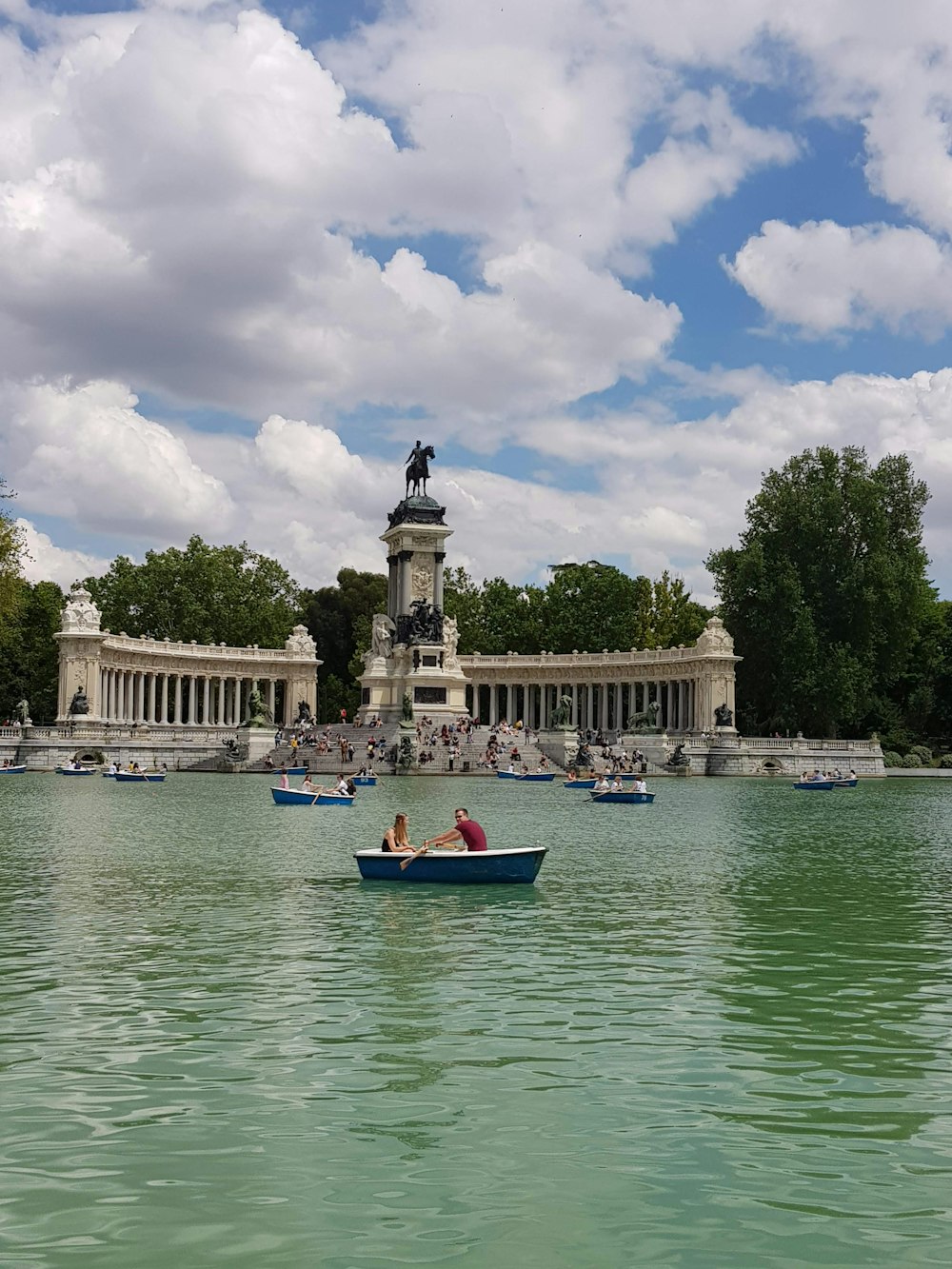 people riding on red boat on river during daytime