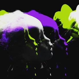 A series of overlapping, silhouetted profiles create a sense of motion and depth, with vibrant green and purple highlights. The profiles emerge from a dark background, accentuating the contrasting colors.