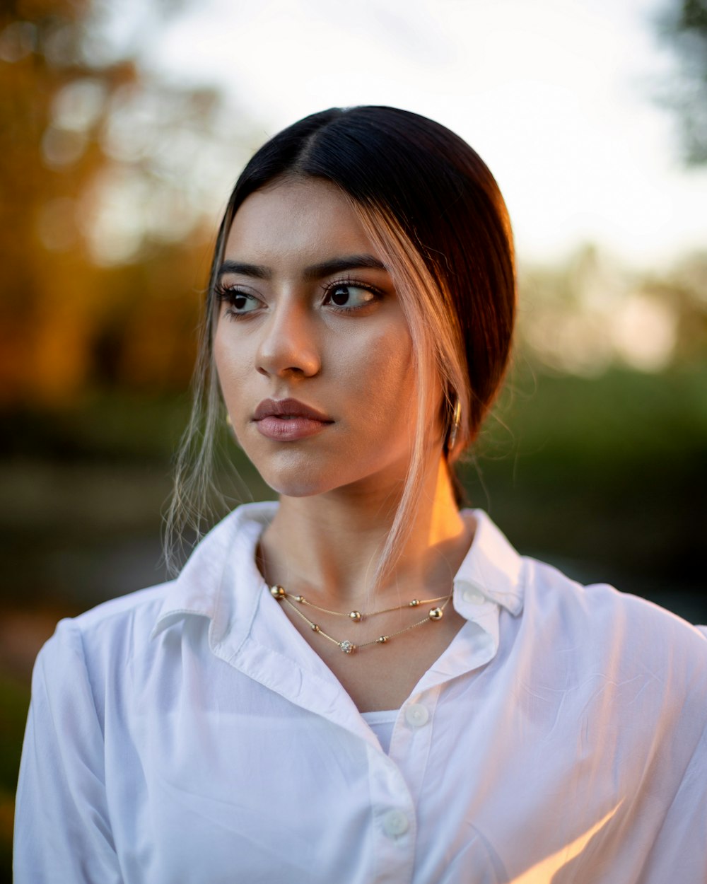 woman in white button up shirt wearing silver necklace