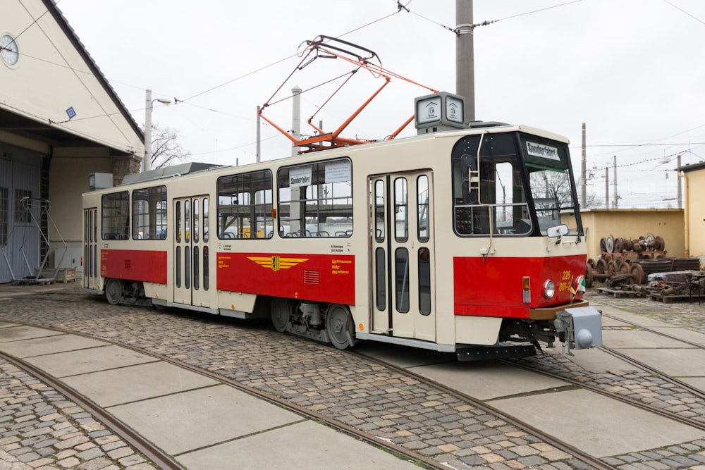 red and white tram on road during daytime