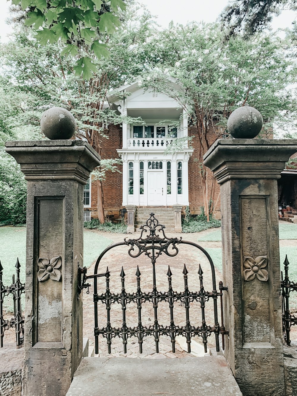 black metal gate near brown concrete building during daytime