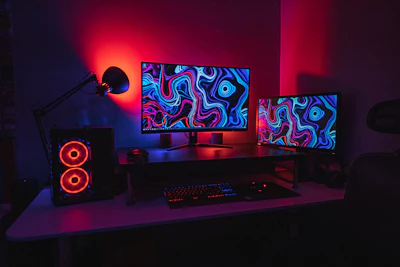 black flat screen computer monitor on black wooden desk