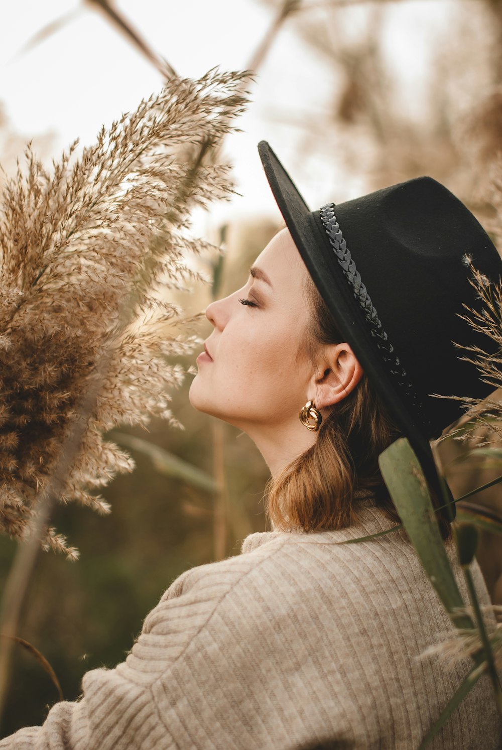 woman in black hat and gray sweater