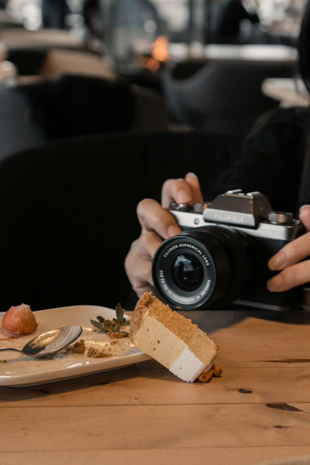 person holding black and silver camera