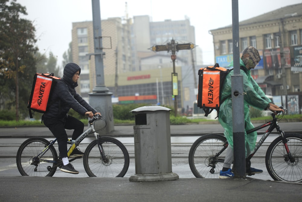 man in black jacket riding bicycle during daytime