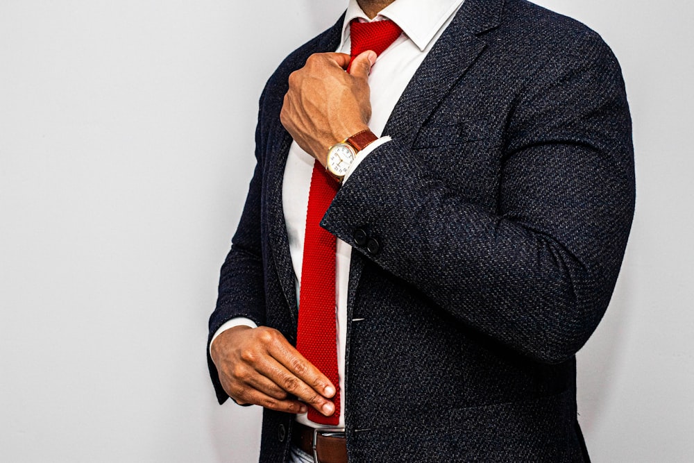 man in black suit jacket and red necktie