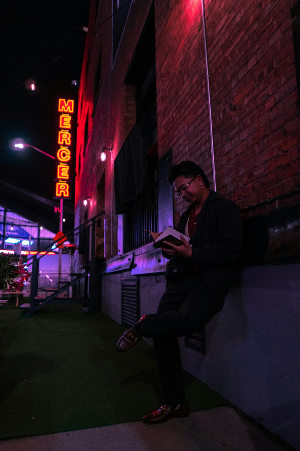 man in black jacket sitting on chair