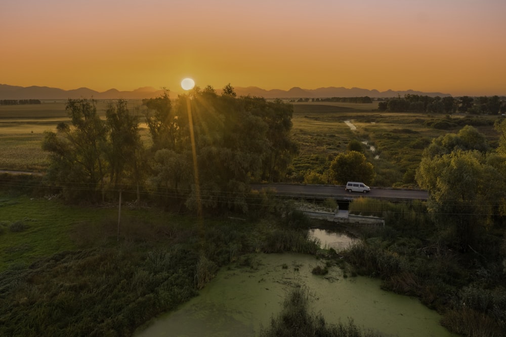 green grass field during sunset