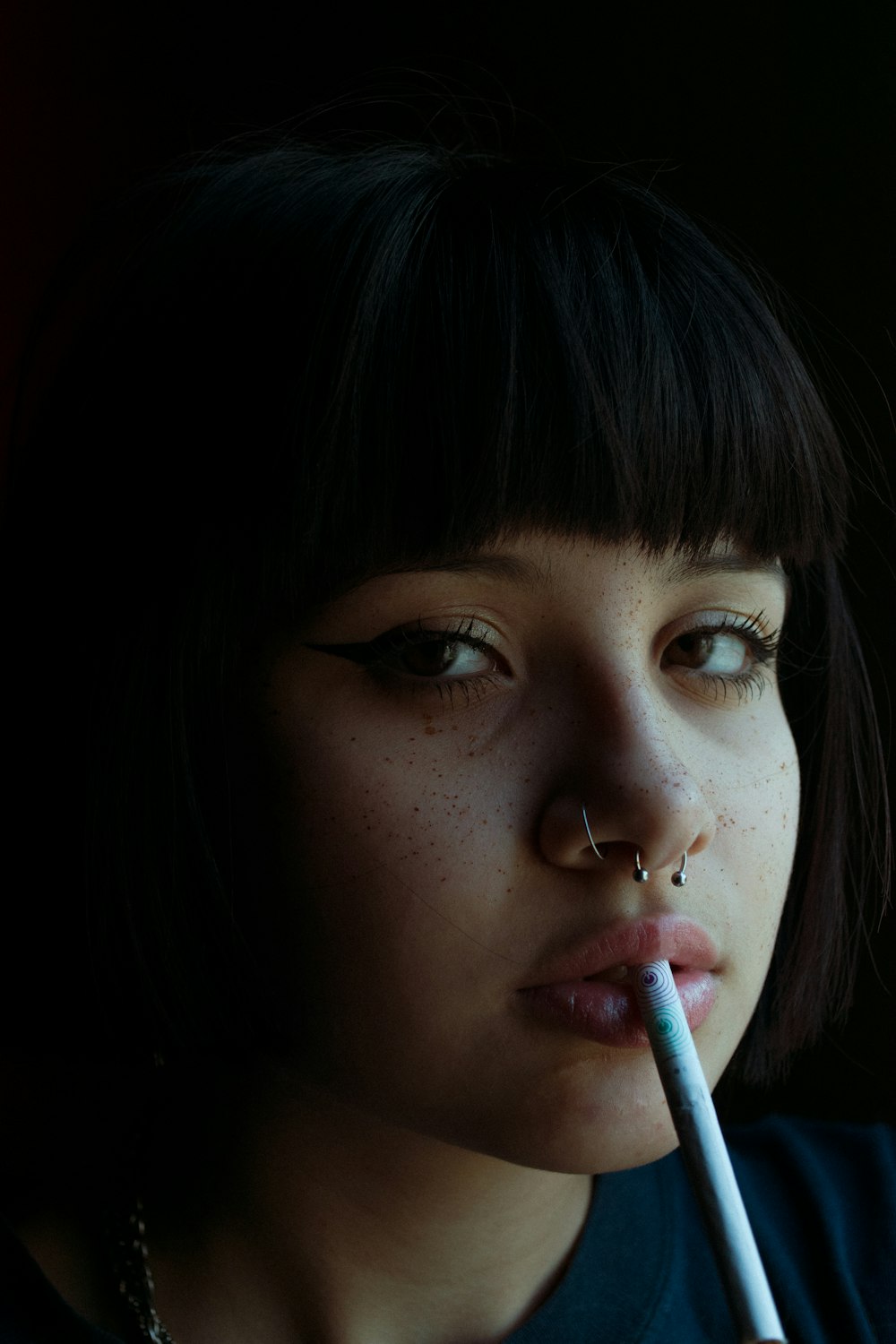 woman with white cigarette stick on her mouth