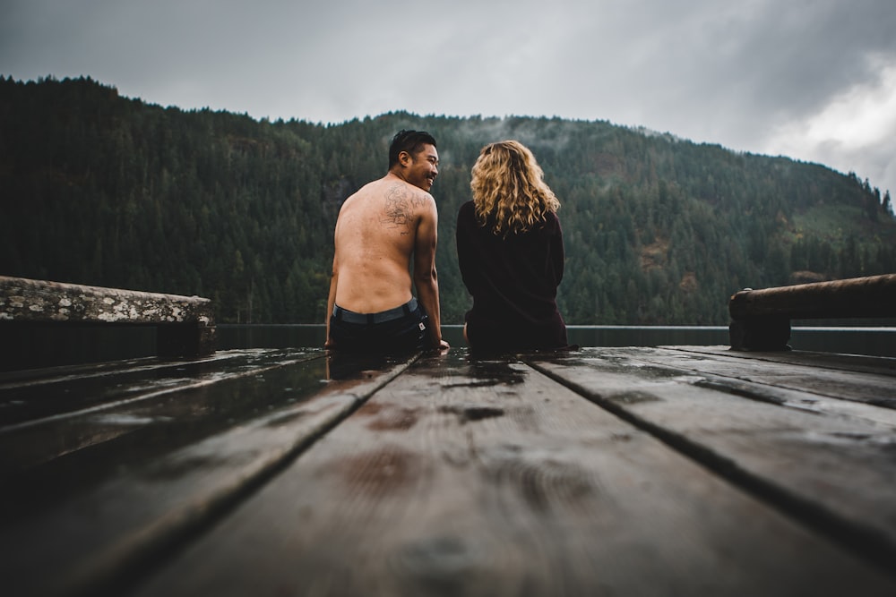 man and woman standing on dock during daytime