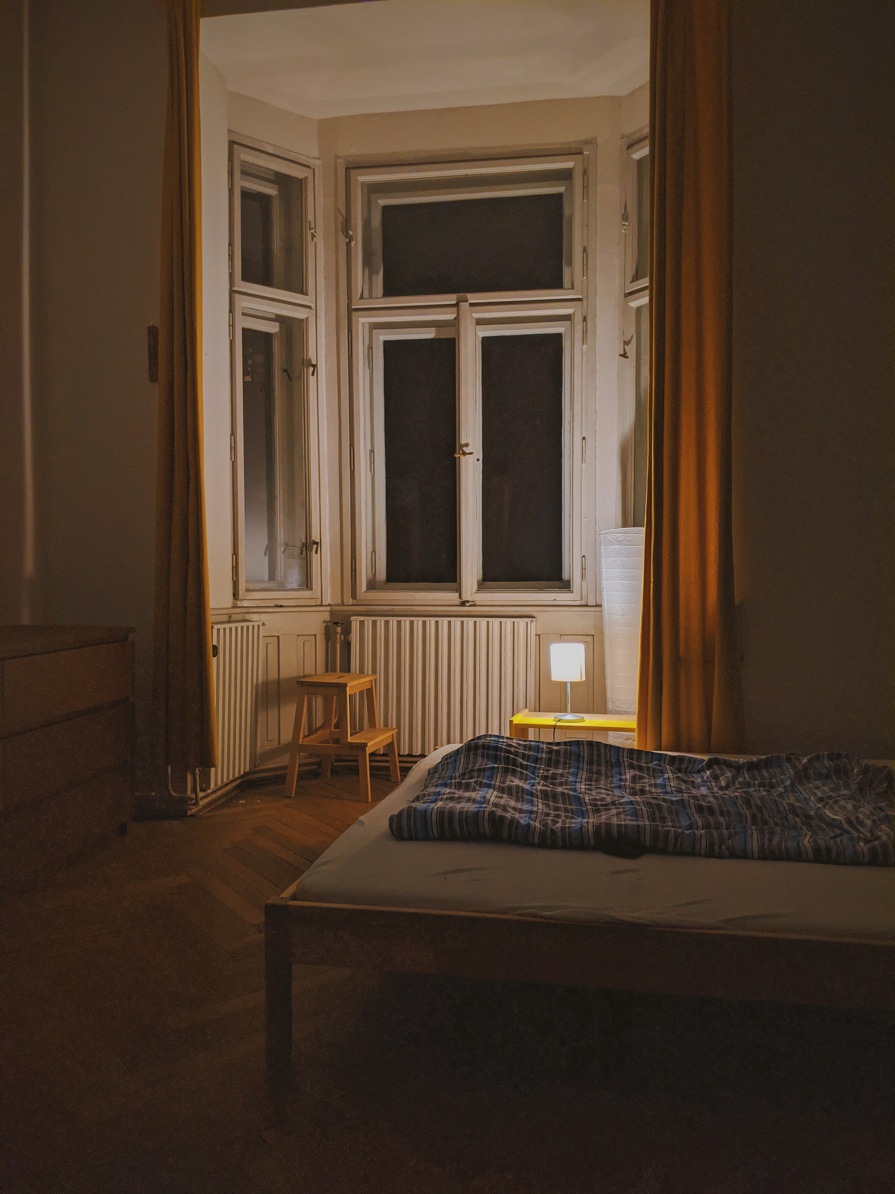 Illustration of a bedroom with dim warm lights