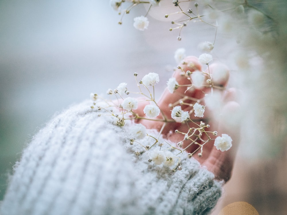 white flowers on white knit textile