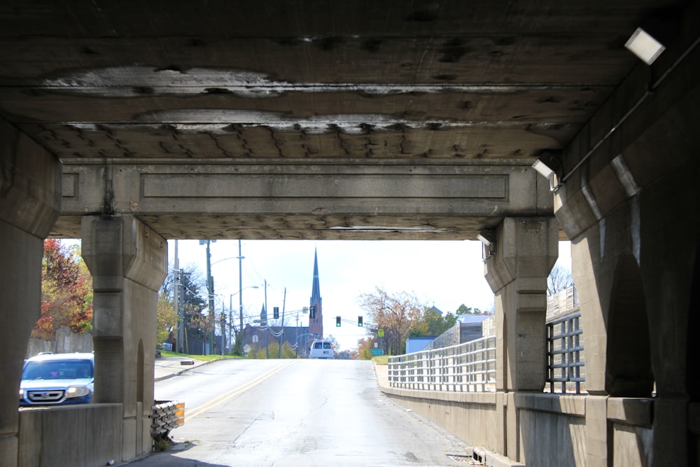 gray concrete road under bridge during daytime