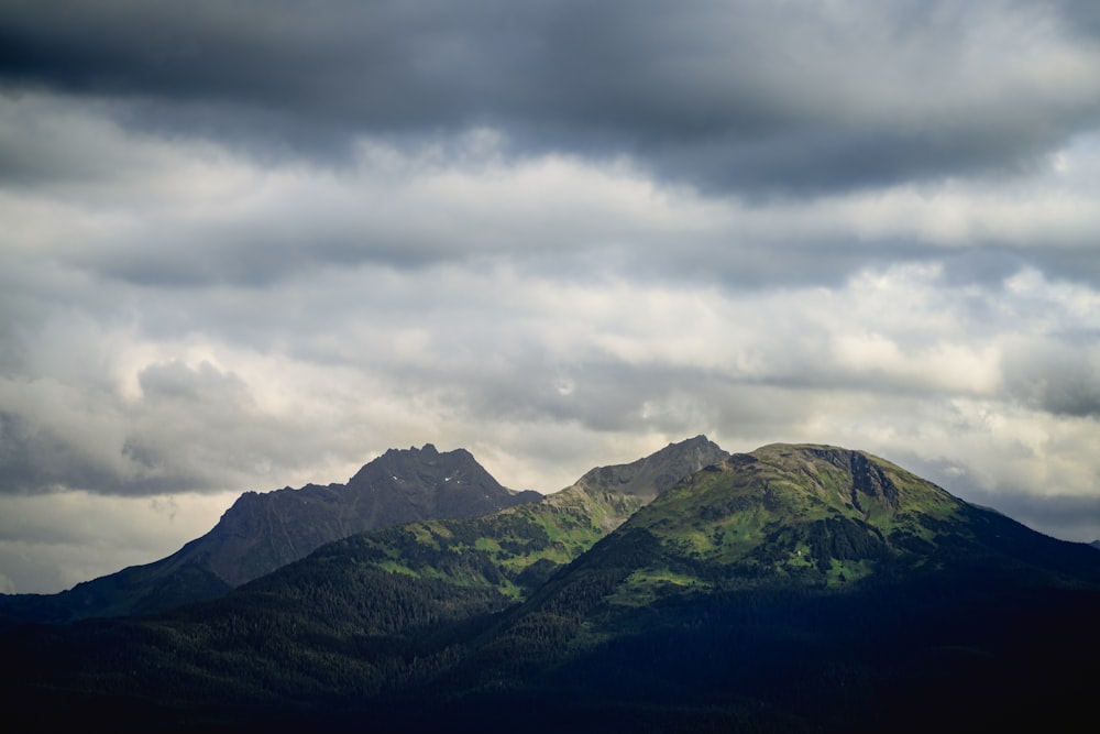 green mountains under white clouds during daytime