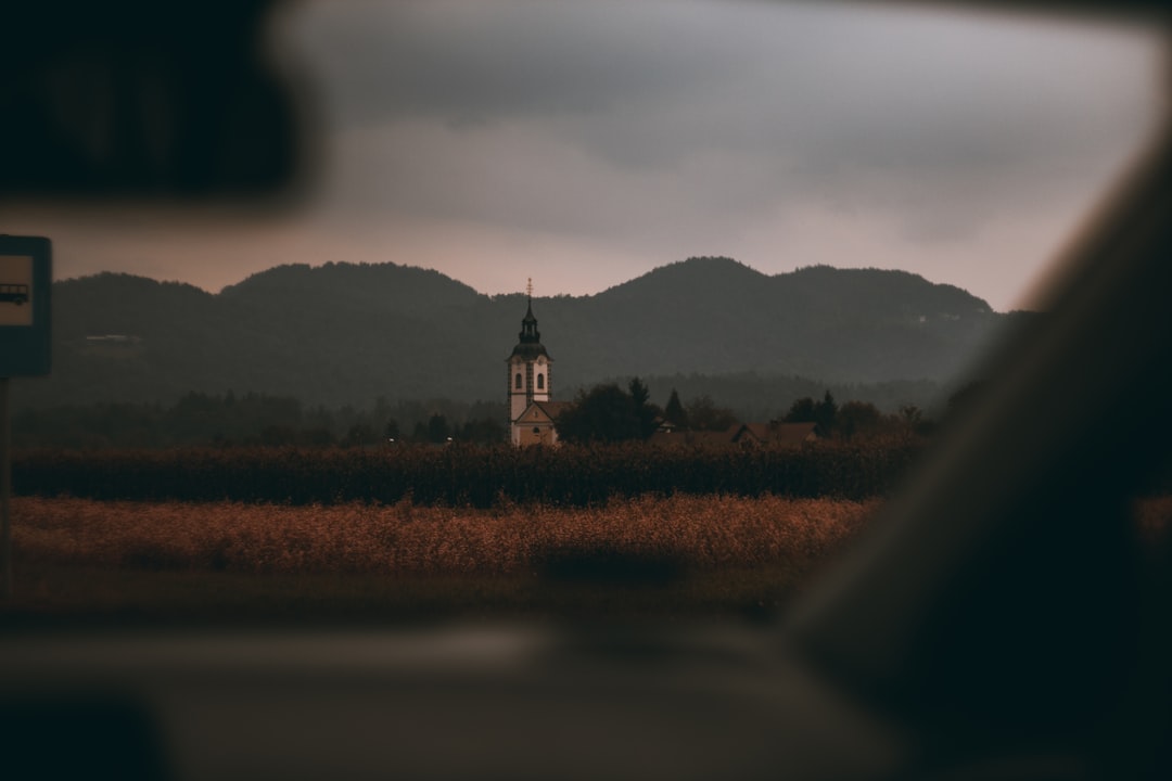 white and black tower near body of water during daytime